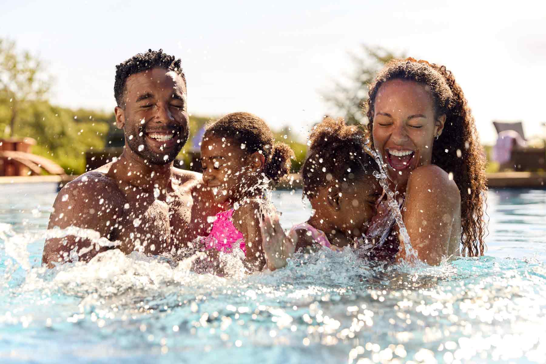 Happy family enjoying time together in a luxury Florida community pool