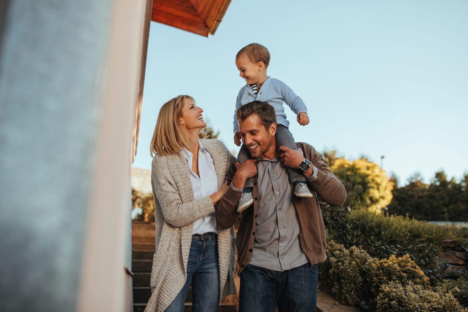 Happy family walking outside a typical Broward County community on a sunny day