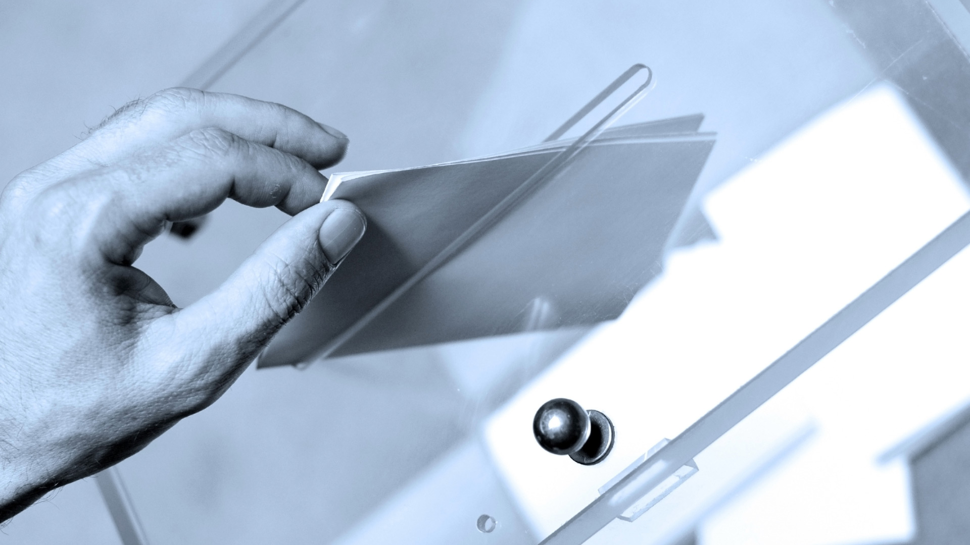 Representative of homeowner submitting ballot in a transparent voting box during HOA board election in Bonita Springs